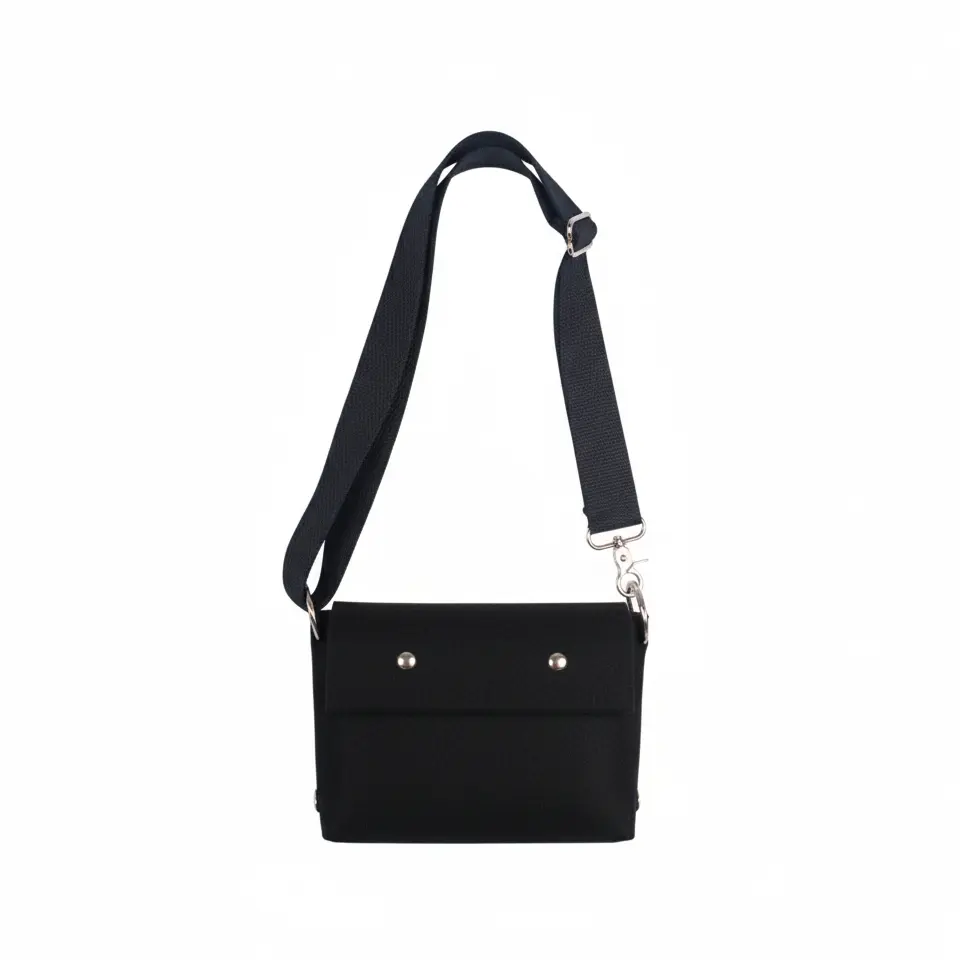 Black crossbody bag with a strap on a white background