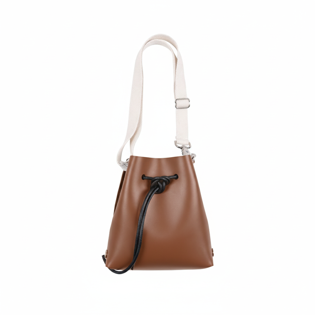 Brown leather handbag with a white strap on a white background