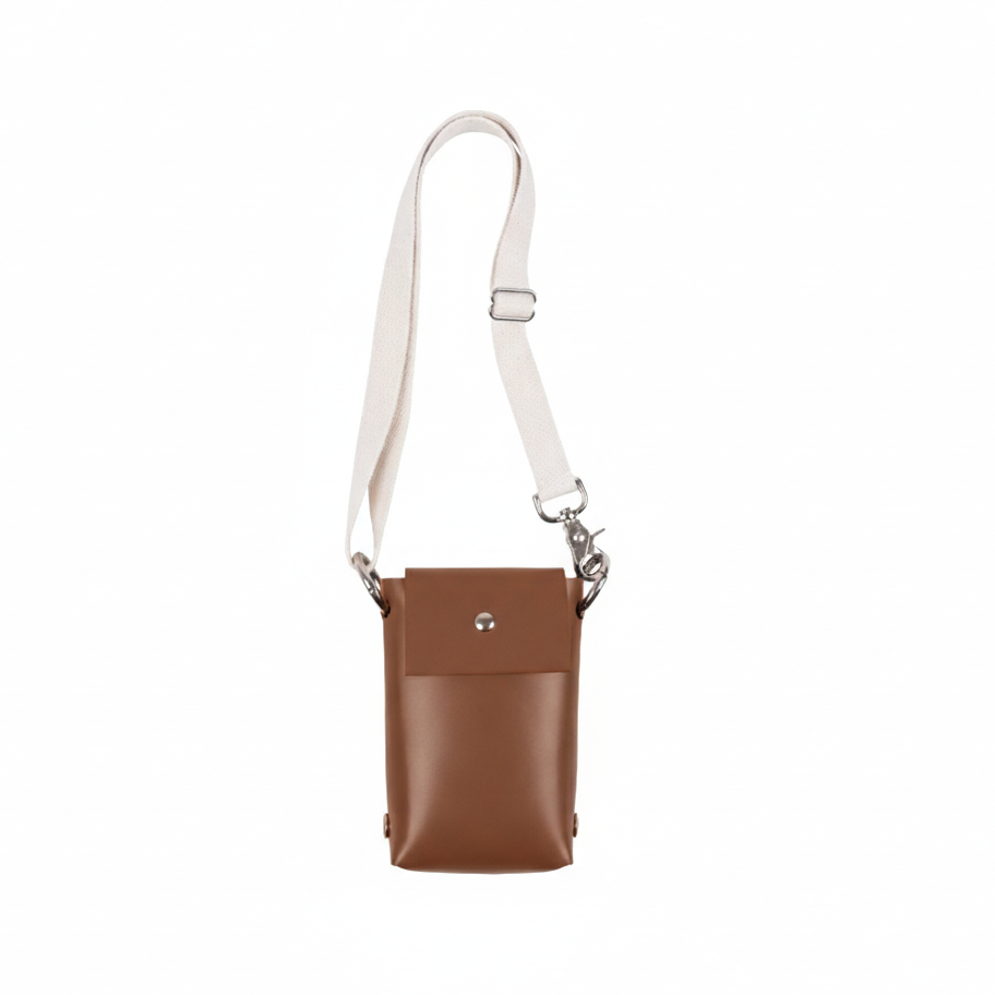 Brown leather crossbody bag with a white strap on a white background