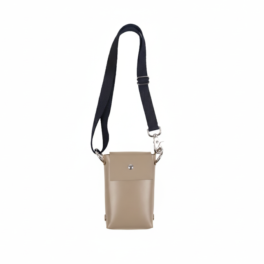 Beige crossbody bag with a black strap on a white background