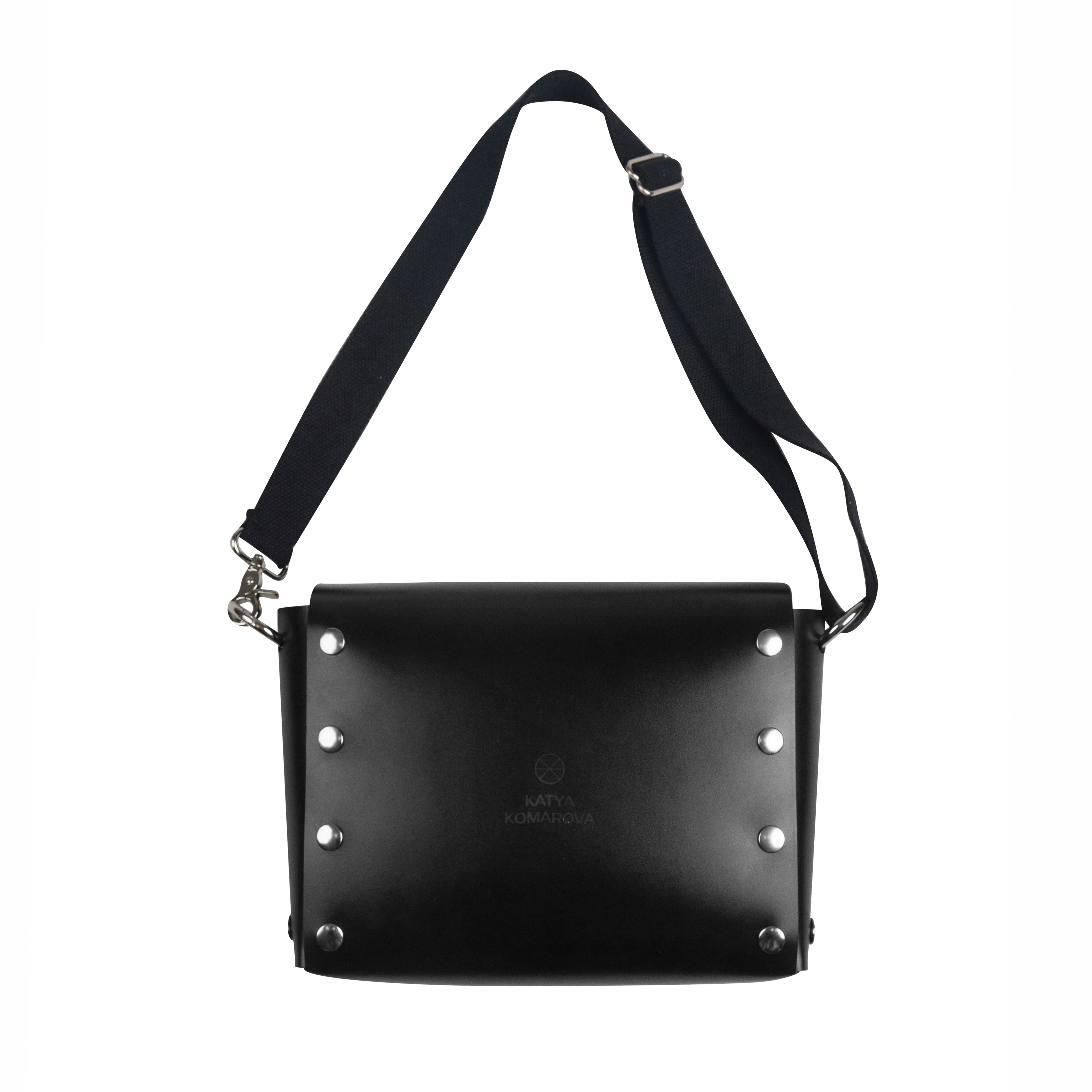 Black shoulder bag with studded details on a white background