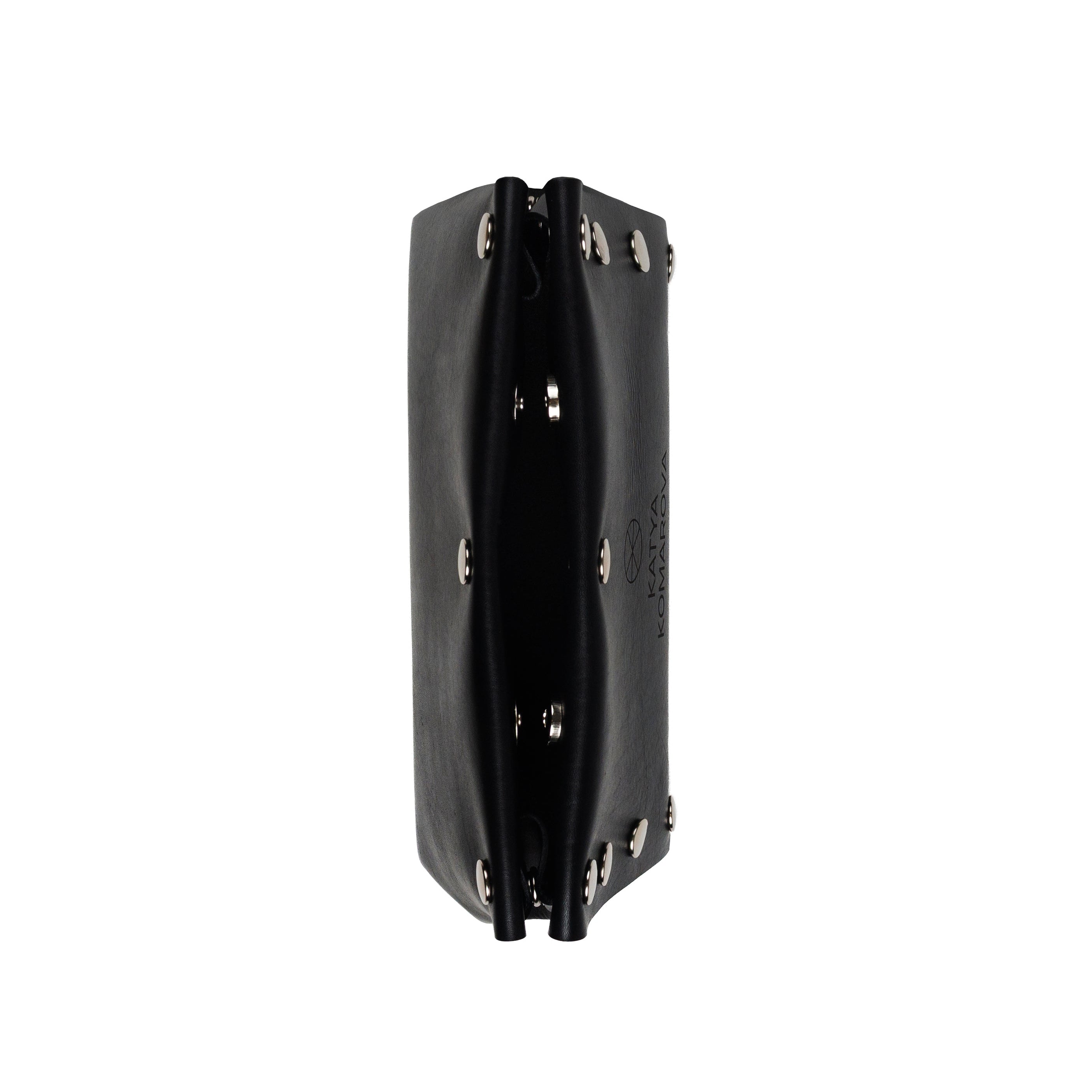 Black rectangular object with multiple ports on a white background