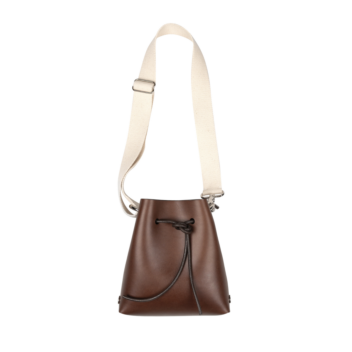 A brown leather bucket bag with an adjustable cream canvas shoulder strap and a black drawstring closure, shown against a plain white background.